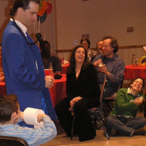 Chicago magician entertains children and adults at a family event, bringing laughter and smiles to everyone at the party!
