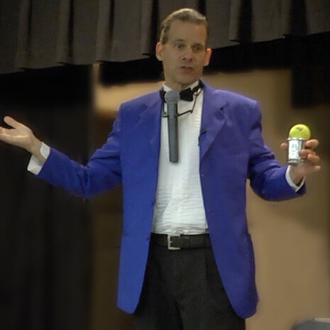 Magician performs sleight-of-hand magic with a cup and ball for a Chicago area audience!